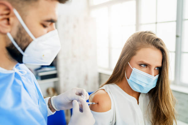 istock Woman having Vaccine Injection 1300930595