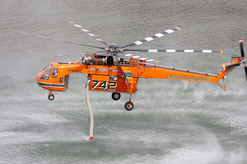 Madras, Oregon, USA - August 29, 2015: An Erickson Air-Crane S-64, named Delilah, fills its water tank from Lake Billy Chinook during firefighting operations just southeast of Madras, Oregon.