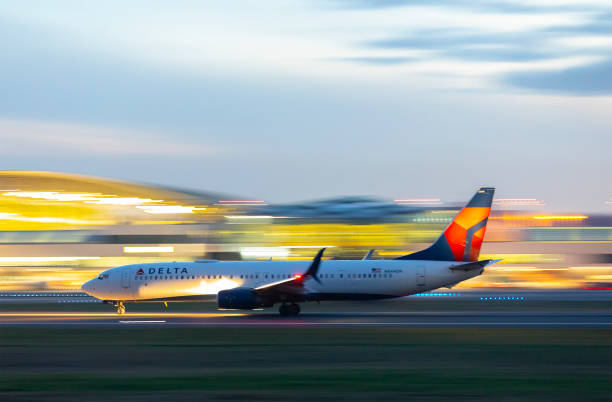 Delta Airlines Night Takeoff. Portland, Oregon, USA - January 17, 2021: A Delta Airlines 737 rolls down runway 10L for takeoff at Portland International Airport. delta stock pictures, royalty-free photos & images
