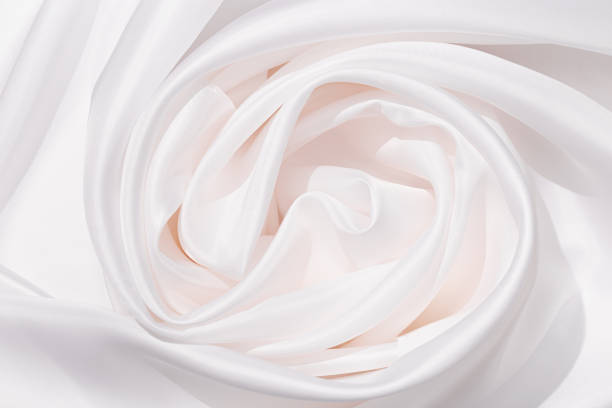 istock Textile linen tablecloth white colored with beautiful pleats. Cloth surface as background. 1300938113