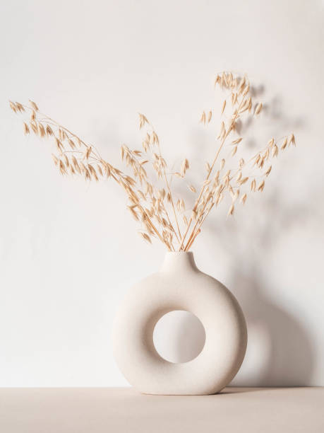 istock Round stylish ceramic vase with dried oats 1300939285