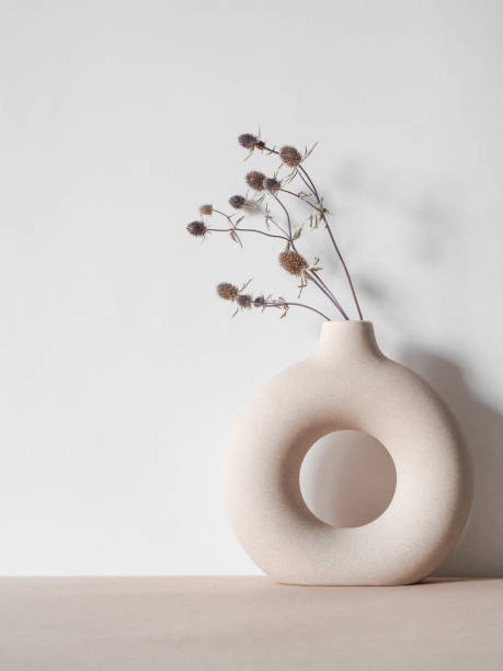 istock Round stylish ceramic vase with dried plant 1300939286