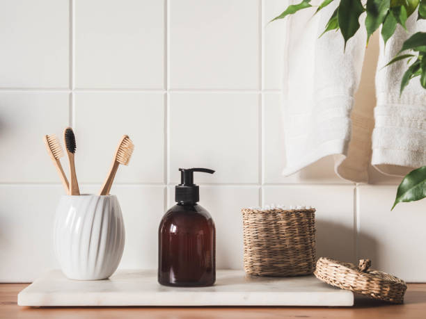 istock White bath background front view with cosmetic bottle and bath accessories 1300939361