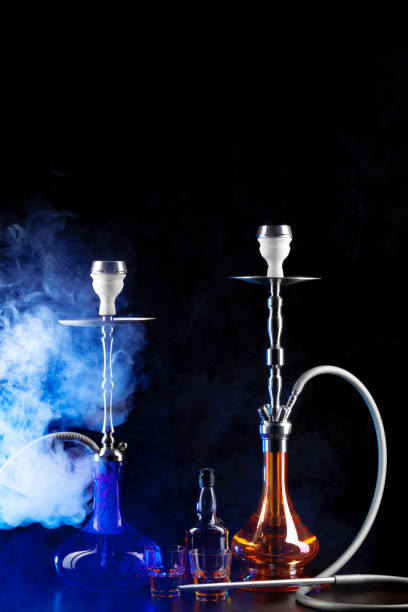 istock Modern hookah with smoke in dark club light 1300941025