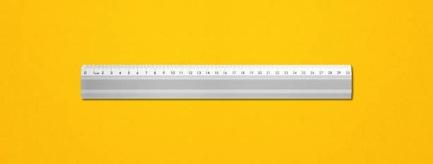 istock Metal ruler isolated on yellow background 1300943264
