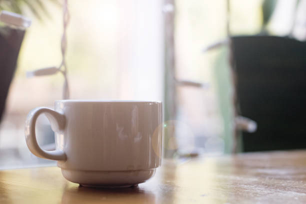istock White cup of coffee on n table on window background 1300943989