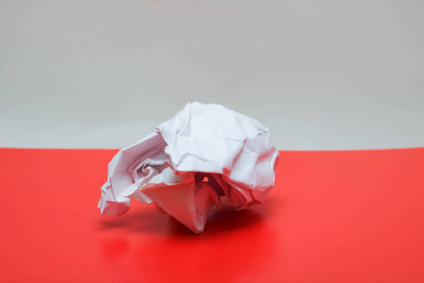 istock Crumpled paper close up on a red table 1300944050