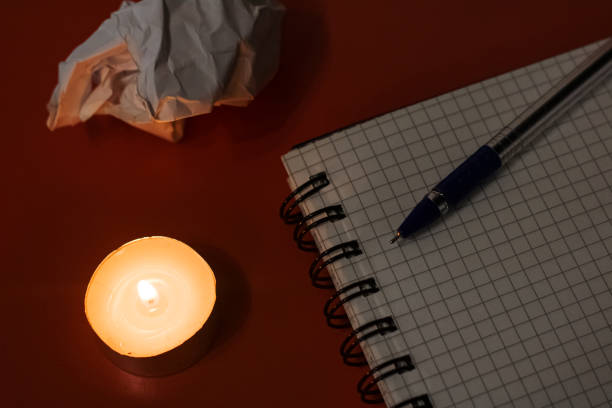 istock Notebook, pen, candle and crumpled sheet of paper 1300944167