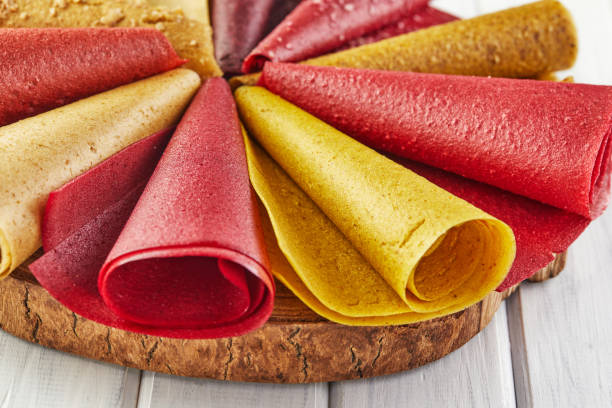 istock Sweet pure fruit pastille in rolls. Healthy sweets - lozenges, fruit chips. Natural sweets from berries and fruits. Diet vitamin food and vegan food 1300945114