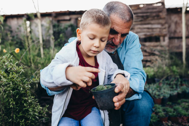 istock grandfather and grandson outdoors in garden 1300946755