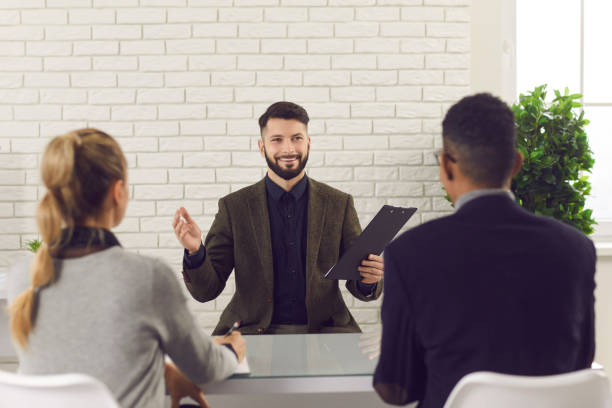 istock Happy job candidate telling about his experience in an interview with HR managers 1300946836