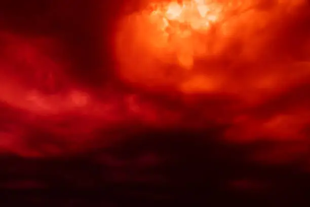 Photo of Fantastic concept mystical horror background from another planet from the paranormal world, fantasy style. Dramatic red black orange sky with scary hellish clouds and terrible shadows and light