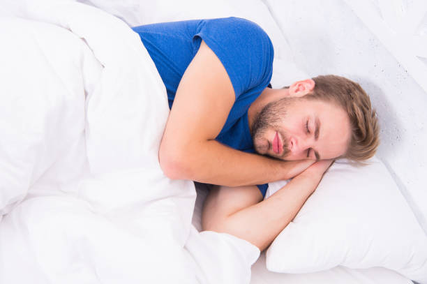 istock Get enough amount of sleep every night. Bearded man sleeping face relaxing. Maintaining consistent circadian rhythm is essential for general health. Man handsome guy sleeping. Tips sleeping better 1300947994