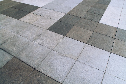 Square and gray tile flooring in perspective.
