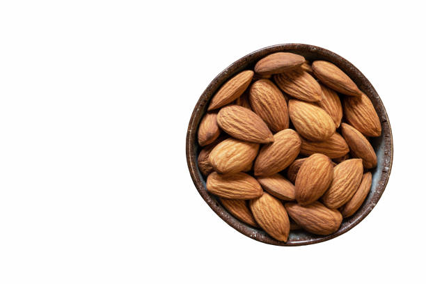 istock Almonds in a bowl isolated on white background. Copy space. Healthy snack. 1300949692