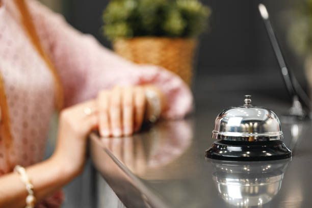 istock Blonde woman standing at front desk hotel reception 1300951832