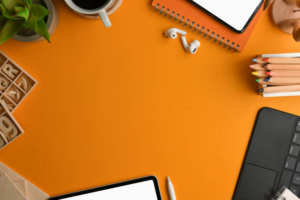 istock Artist workspace with stationery, craft element, digital device and copy space on yellow table 1300953417