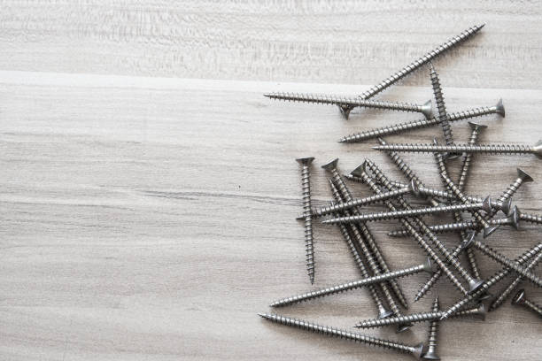 istock Chrome screws scattered on the floor, repair concept. 1300954201