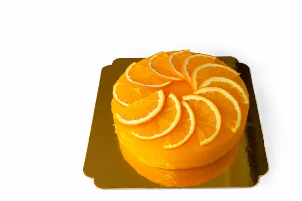 Closeup orange cake delicious on glass table background, selective focus