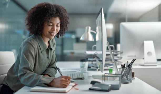Don't tell people your plans, show them your results Shot of a young female agent working in a call centre smiling while taking notes secretary stock pictures, royalty-free photos & images
