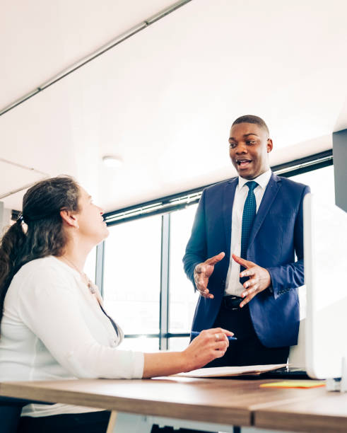 istock Businessman discussing work with a colleague 1300957928