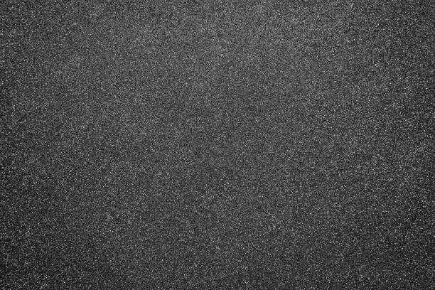 istock paper dark gray background with shiny splashes 1300959256