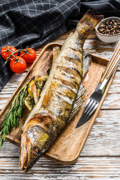 istock Grilled pike perch, pikeperch fish. White wooden background. Top view 1300961087