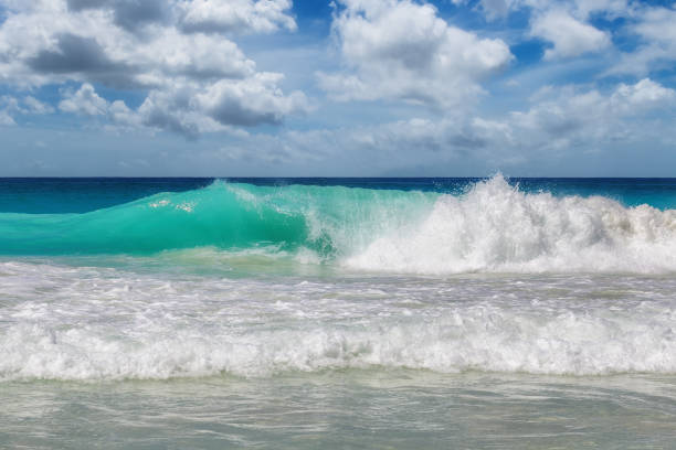 Blue sea wave with white foam, clear turquoise water in tropical island
