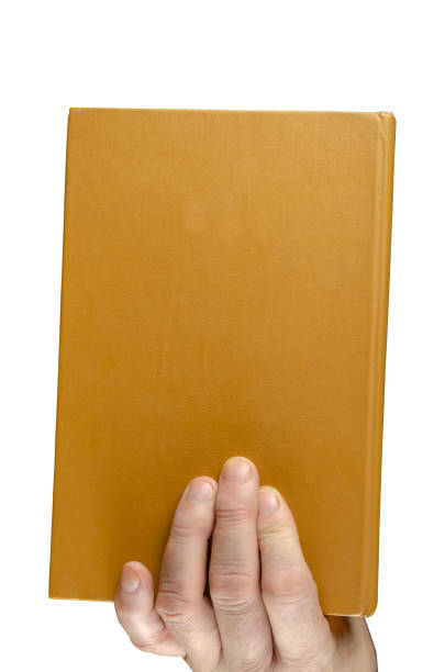 istock A man's hand holds an old closed book. 1300963909