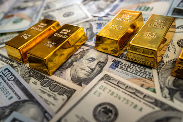 istock gold bar on 100 dollar bills 1300964602