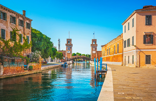 Venice cityscape, water canal, bridge and gate of medieval Venetian Arsenal or Arsenale di Venezia. Italy