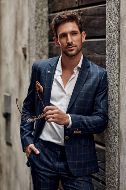 istock Young handsome man in classic suit with sunglasses 1300966276