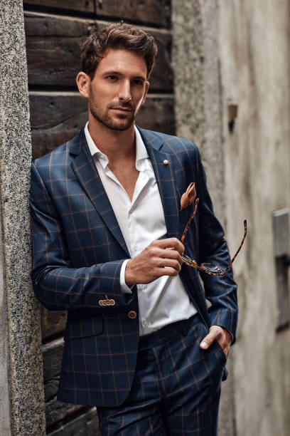 istock Young handsome man in classic suit with sunglasses 1300966309
