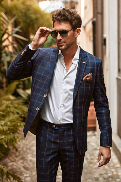 istock Young handsome man in classic suit wear sunglasses 1300966414