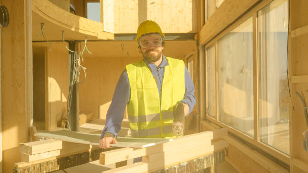 istock PORTRAIT: Young Caucasian builder smiles after cutting up a gypsum wallboard. 1300966416