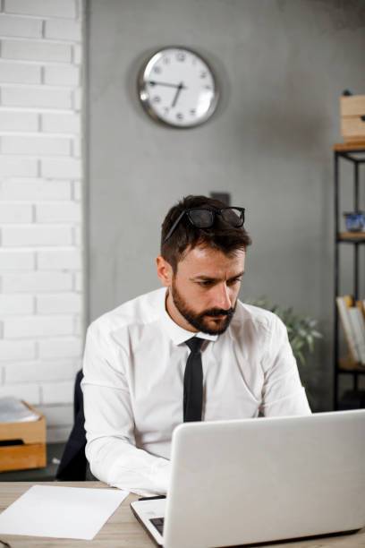 istock Young businessman working on laptop at office 1300966583