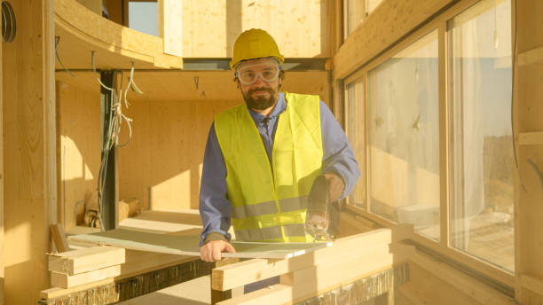 istock PORTRAIT: Young Caucasian builder smiles after cutting up a plaster wallboard. 1300966663