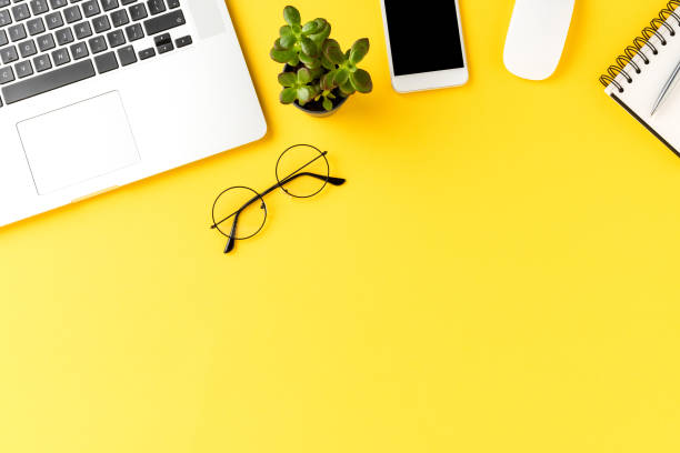 istock Business background with laptop and accessories. Office desktop with copyspace 1300966719