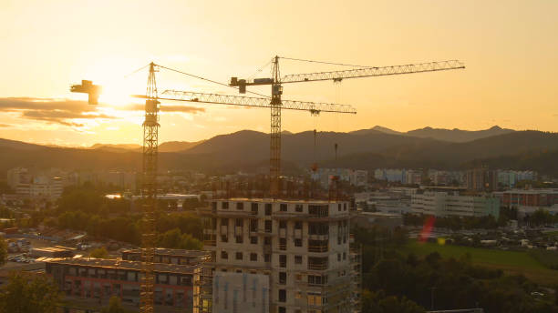 istock AERIAL: Flying toward apartment building under construction surrounded by cranes 1300966730