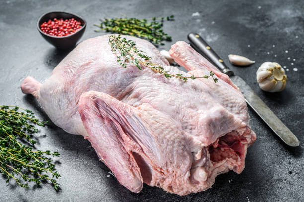 istock Raw free range duck with spices ready to cook. dark background. Top view 1300966738