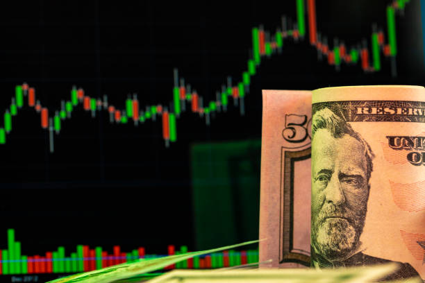 istock American dollar banknotes and graph on black background 1300967655