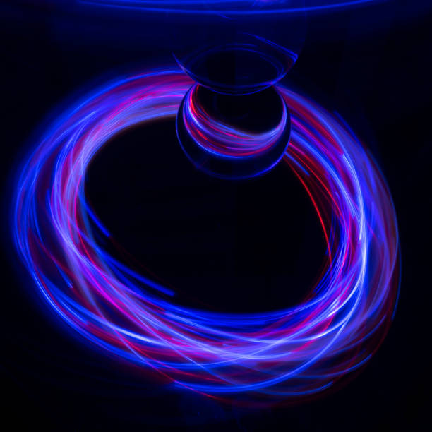 Lightpainting with small lights on a mirror Light painting with small lights on a mirror. On the mirror are elements such as ice, glass ball, light bulb and drinking glass lightpainting stock pictures, royalty-free photos & images