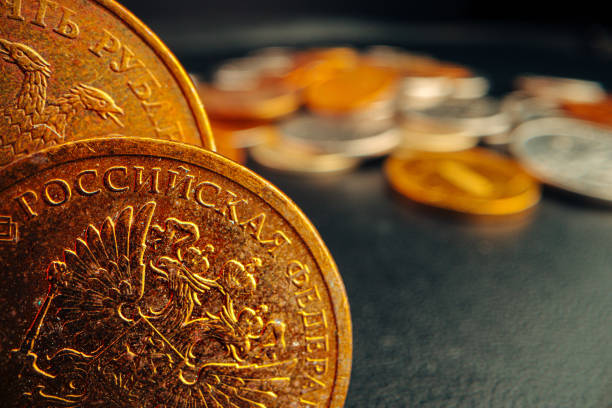 istock Russian rouble coin on dark background close up 1300970075