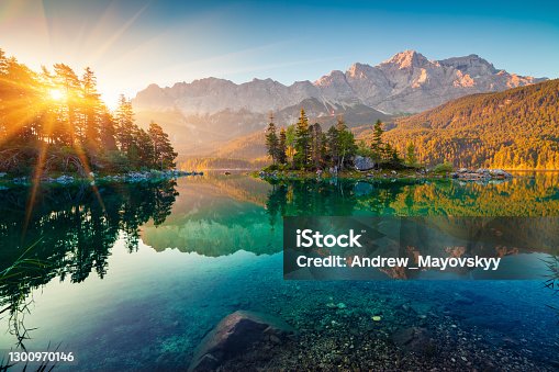 istock Impressive summer sunrise on Eibsee lake with Zugspitze mountain range. Sunny outdoor scene in German Alps, Bavaria, Germany, Europe. Beauty of nature concept background. 1300970146