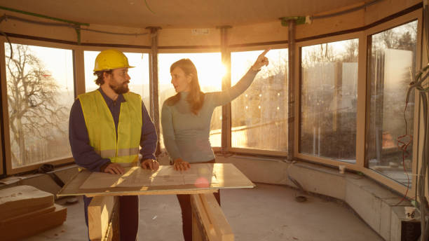 istock Beautiful woman and worker look around the room while analysing the floor plans 1300970729