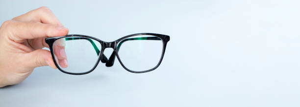 istock Person Holding Black Eyeglasses 1300971201