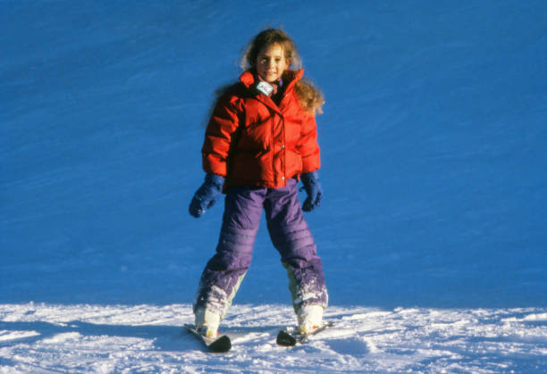istock A child quietly descends a ski slope 1300972544