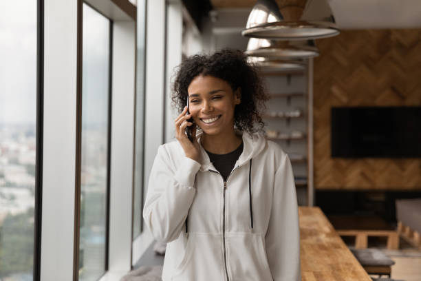 istock Young black woman make phone call in good mood 1300972562