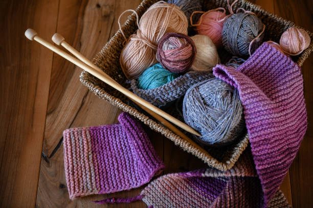 istock Accessories for knitting in basket ( yarn, needles) and scarf 1300972945
