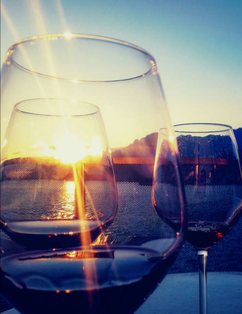 istock glasses of red wine with sea and setting sun 1300973032